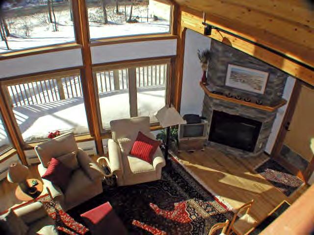 63 Algerie Road Becket, MA 01223 - Photo 4 of 5 a living room with furniture a rug and a floor to ceiling window
