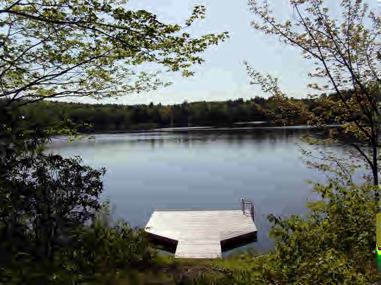 63 Algerie Road Becket, MA 01223 - Photo 5 of 5 an aerial view of a house with a yard and lake view