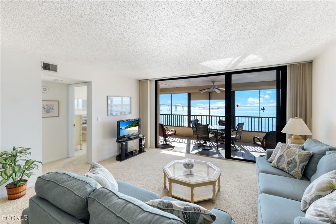 15011 Punta Rassa Road, Unit 505 Fort Myers, FL 33908 - Photo 11 of 40 a living room with furniture and a large window