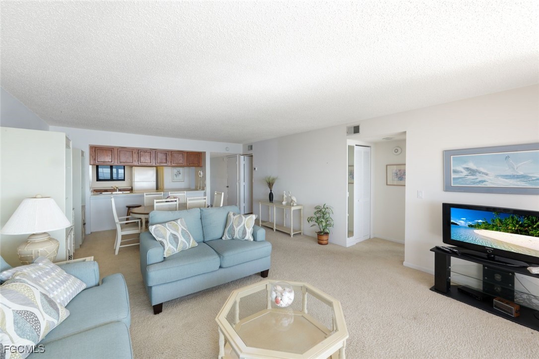 15011 Punta Rassa Road, Unit 505 Fort Myers, FL 33908 - Photo 12 of 40 a living room with furniture and a lamp