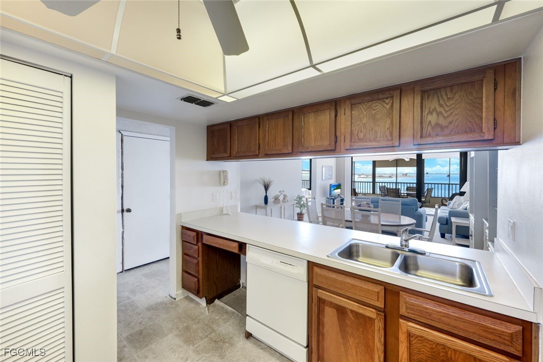 15011 Punta Rassa Road, Unit 505 Fort Myers, FL 33908 - Photo 14 of 40 a kitchen with stainless steel appliances granite countertop a sink and a cabinets