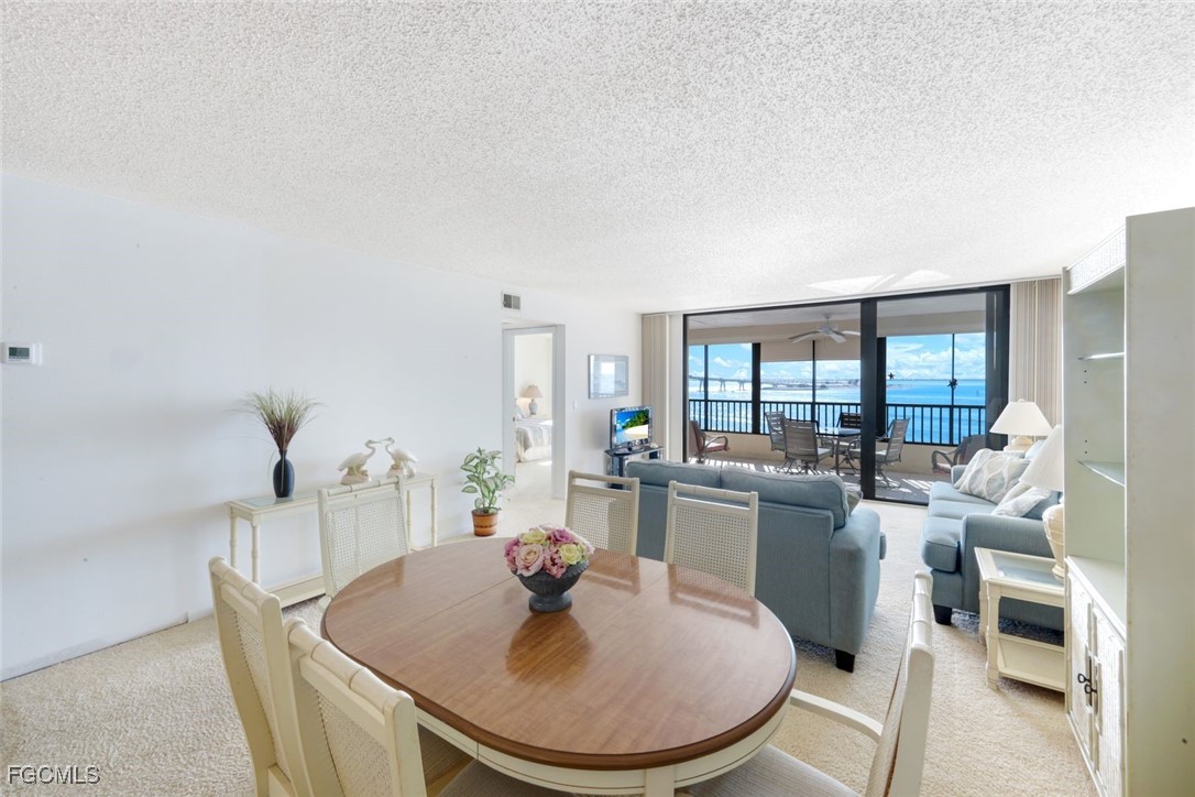 15011 Punta Rassa Road, Unit 505 Fort Myers, FL 33908 - Photo 19 of 40 a dining room with furniture and wooden floor