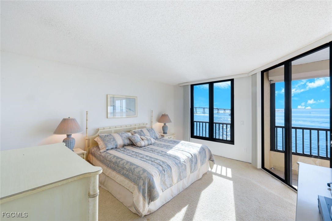 15011 Punta Rassa Road, Unit 505 Fort Myers, FL 33908 - Photo 20 of 40 a bedroom with a large bed and a large window
