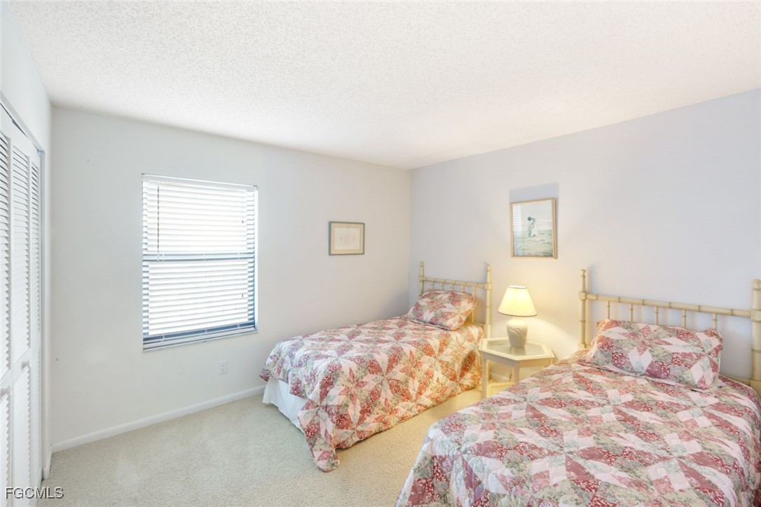 15011 Punta Rassa Road, Unit 505 Fort Myers, FL 33908 - Photo 23 of 40 a bedroom with a bed and wooden floor