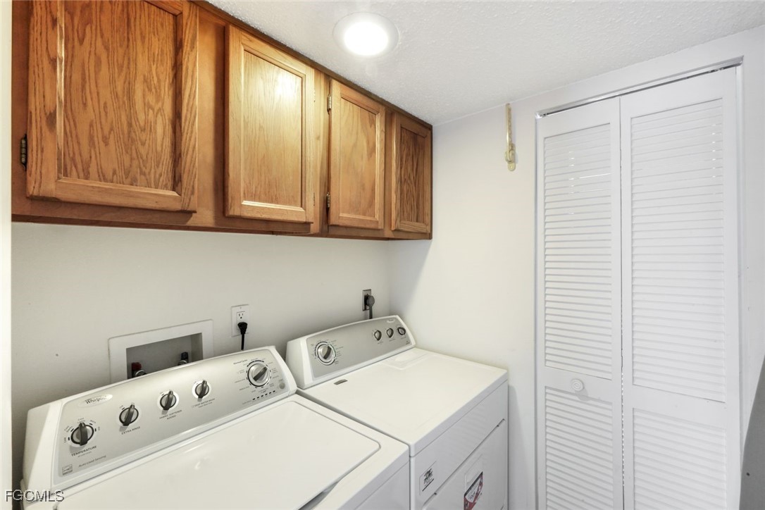 15011 Punta Rassa Road, Unit 505 Fort Myers, FL 33908 - Photo 25 of 40 a utility room with dryer and washer
