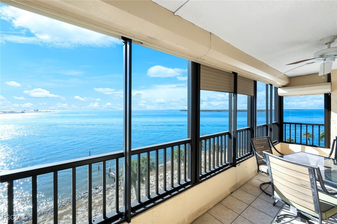 15011 Punta Rassa Road, Unit 505 Fort Myers, FL 33908 - Photo 26 of 40 a view of a balcony with chair and wooden floor