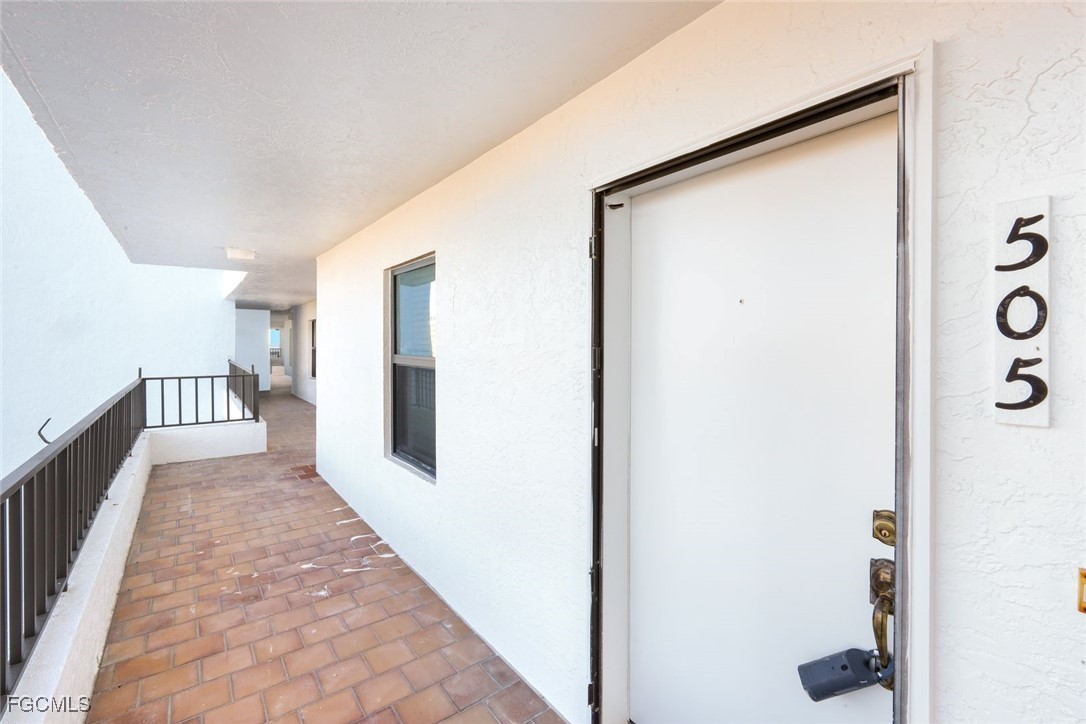 15011 Punta Rassa Road, Unit 505 Fort Myers, FL 33908 - Photo 8 of 40 a view of a hallway with wooden floor and staircase