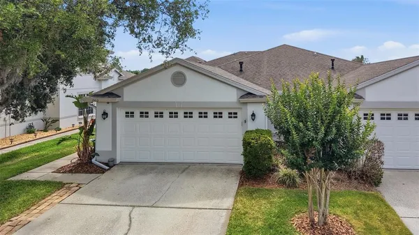 a view of a house with a yard and plants