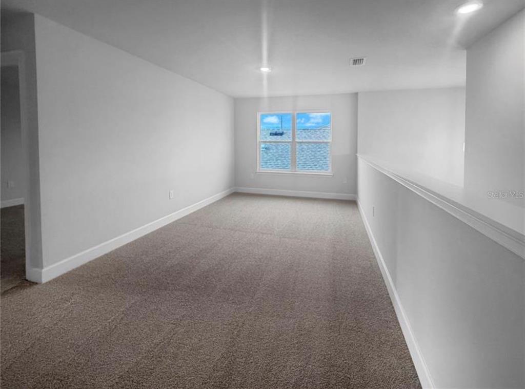 7643 Bent Tree Loop St. Cloud, FL 34773 - Photo 4 of 7 a view of a hallway with a window