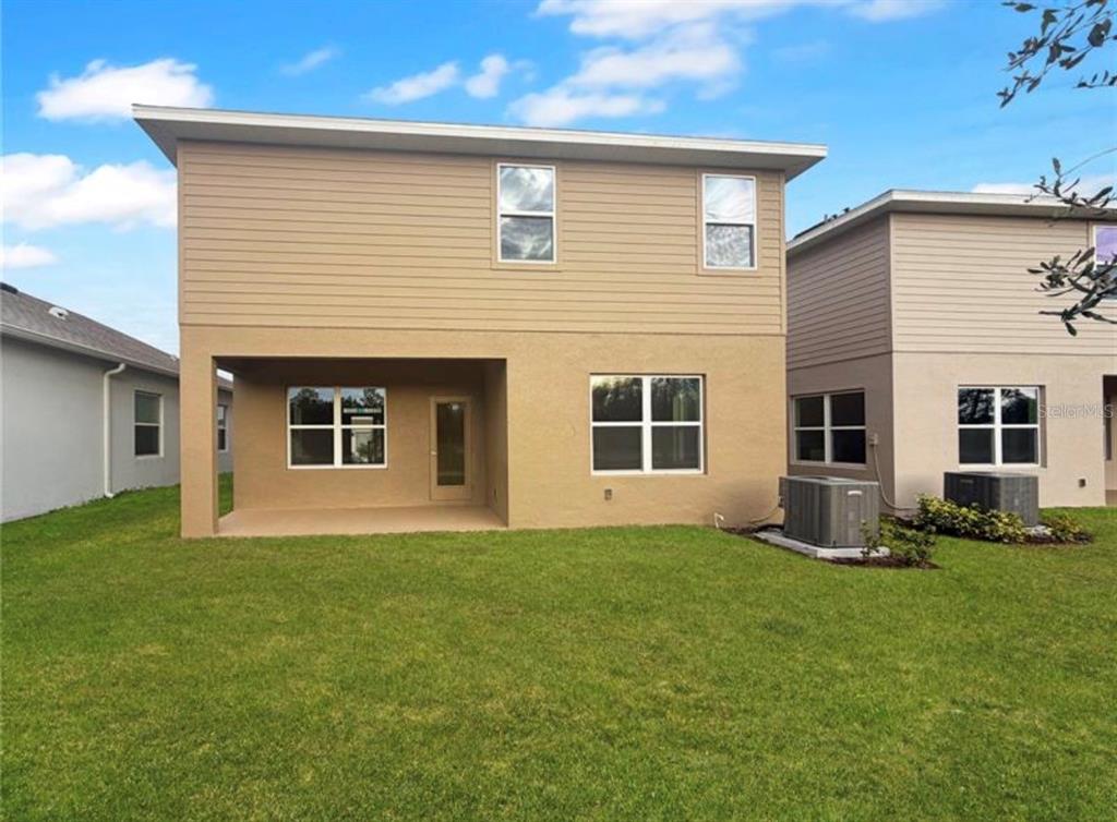 7643 Bent Tree Loop St. Cloud, FL 34773 - Photo 6 of 7 a front view of house with yard