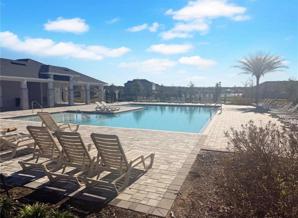 7643 Bent Tree Loop St. Cloud, FL 34773 - Photo 7 of 7 a view of a lake with a terrace