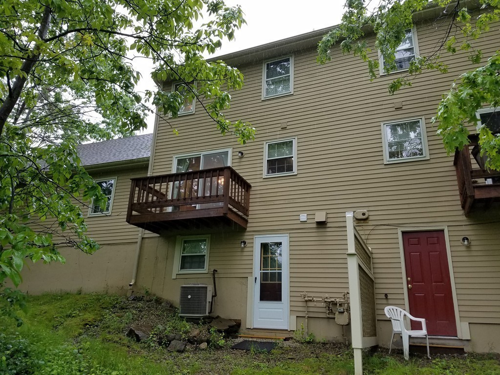 241 Winding Pond Road, Unit 241 Londonderry, NH 03053 - Photo 19 of 30 a view of a house with brick walls and a tree