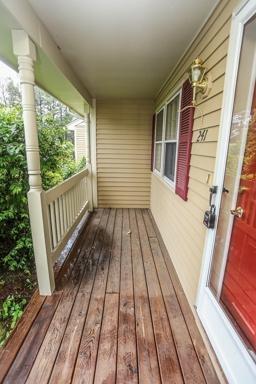 241 Winding Pond Road, Unit 241 Londonderry, NH 03053 - Photo 23 of 30 a view of a balcony with wooden floor