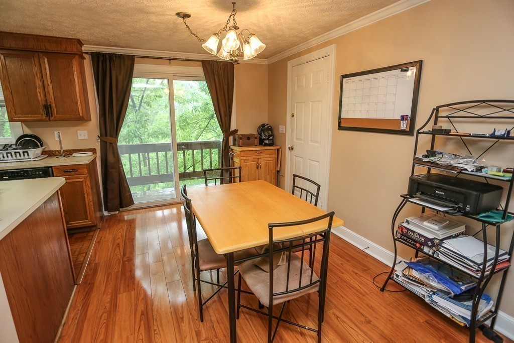 241 Winding Pond Road, Unit 241 Londonderry, NH 03053 - Photo 7 of 30 a view of a dining room with furniture window and outside view
