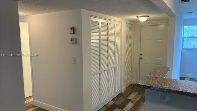 a bathroom with a granite countertop sink and shower