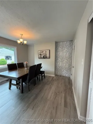 a view of a livingroom with furniture and a workspace