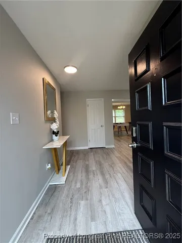 a view of work space with furniture and wooden floor