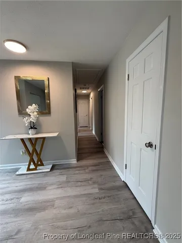 a view of a livingroom with wooden floor and bench