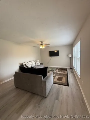 a living room with furniture and wooden floor