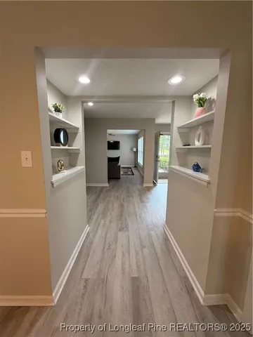 a view of a refrigerator in kitchen and wooden floor