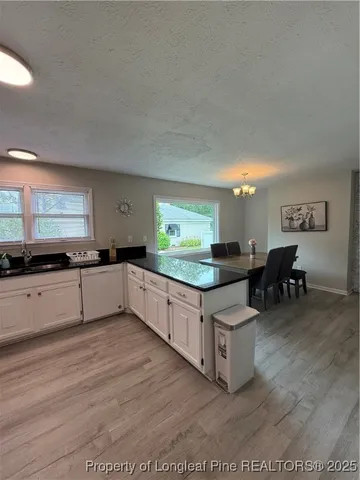 a kitchen with stainless steel appliances kitchen island granite countertop a stove a sink and a refrigerator