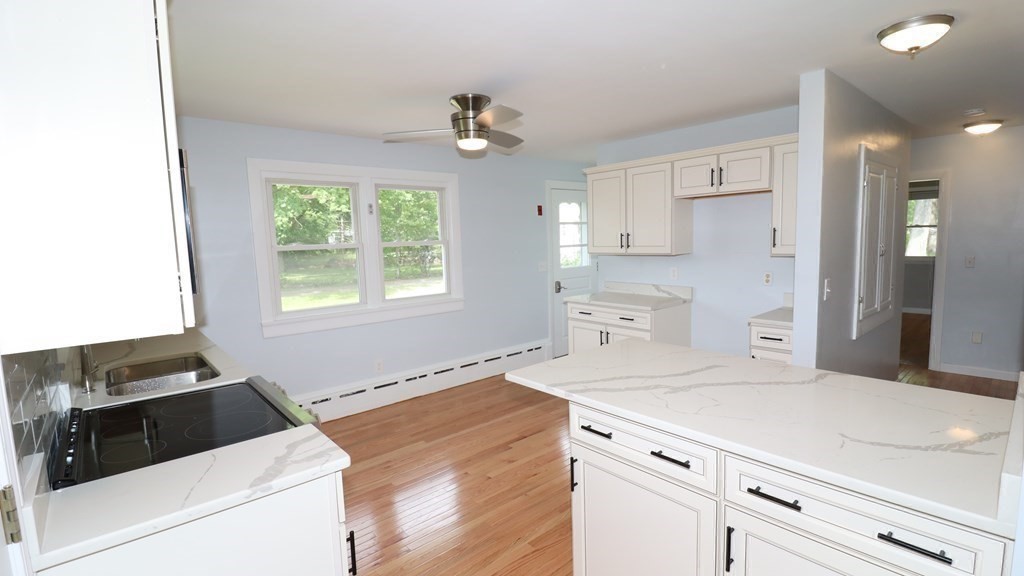 161 Lancaster Road Berlin, MA 01503 - Photo 6 of 41 a kitchen with a stove cabinets and a window