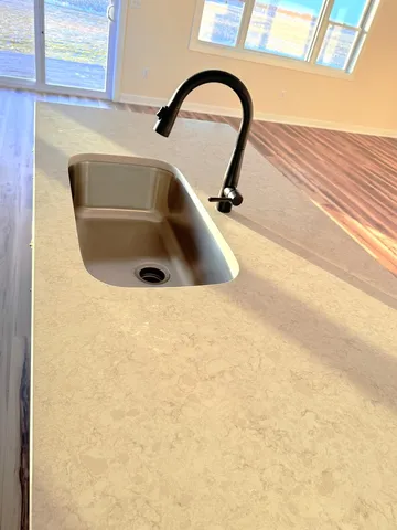 a view of a livingroom with a ceiling fan and window