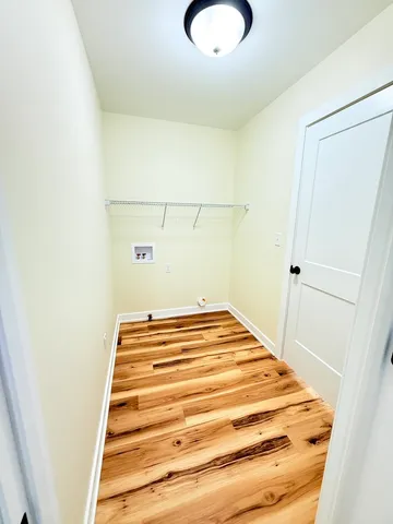 a view of wooden floor with brick walls