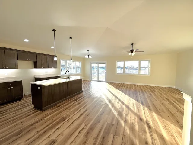 a large kitchen with kitchen island a sink stainless steel appliances and cabinets