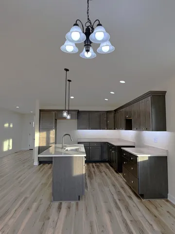 a large kitchen with stainless steel appliances kitchen island granite countertop a sink and cabinets