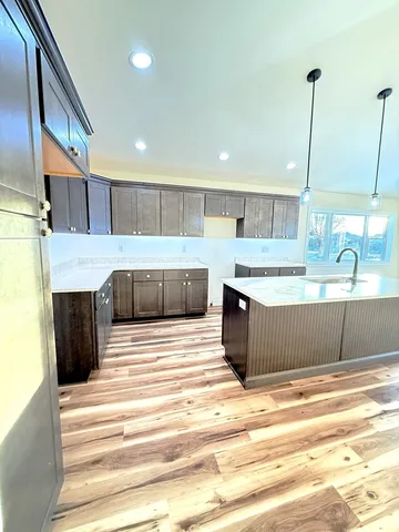 a kitchen with kitchen island sink and stove