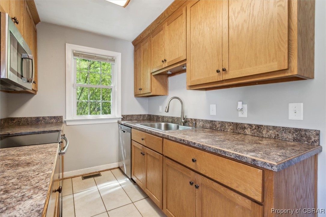 3810 Kecoughtan Road Hampton, VA 23669 - Photo 17 of 40 Kitchen with stainless steel appliances, light tile patterned flooring, and sink