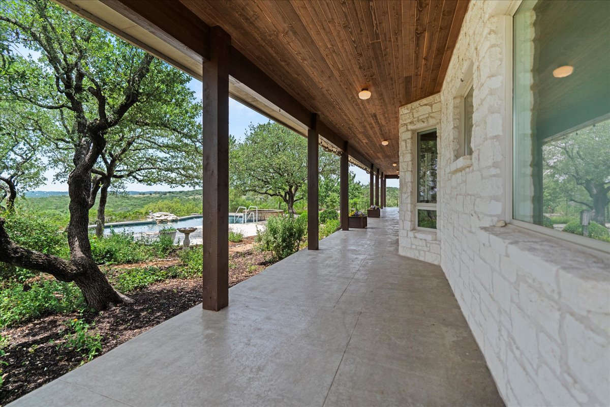 167 Wimberley Ranch Drive Wimberley, TX 78676 - Photo 34 of 40 a view of a house with a large trees next to a yard