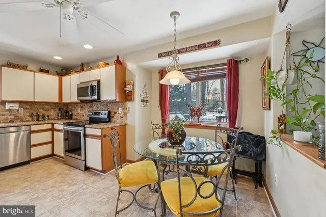 a dining room with furniture a chandelier and wooden floor