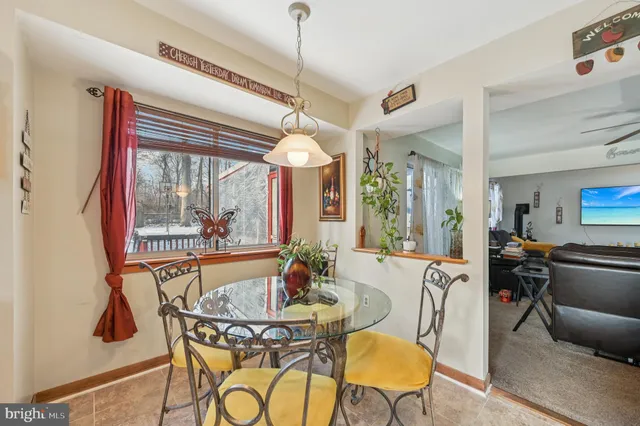 a view of a dining room with furniture a chandelier and wooden floor