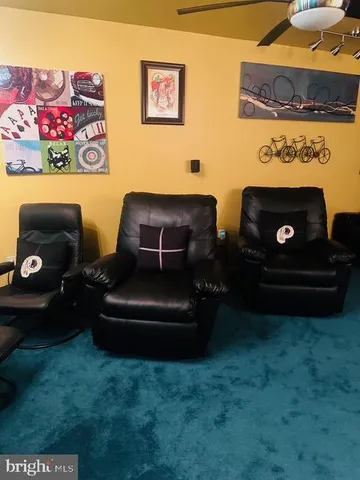 a view of a balcony with chairs and wooden fence