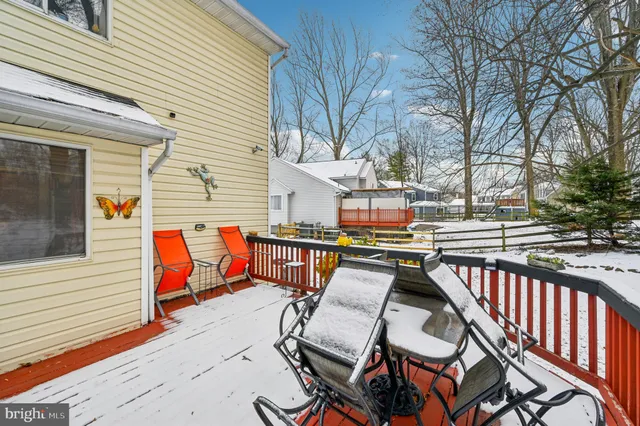 a view of a park with snow on the road