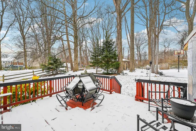 a view of a backyard with snow on the road