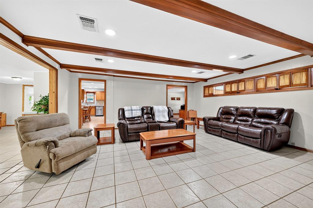 111 County Road 2806 Mabank, TX 75147 - Photo 9 of 34 Spacious room featuring light-toned tile flooring, recessed lighting, and wood-finish ceiling beams