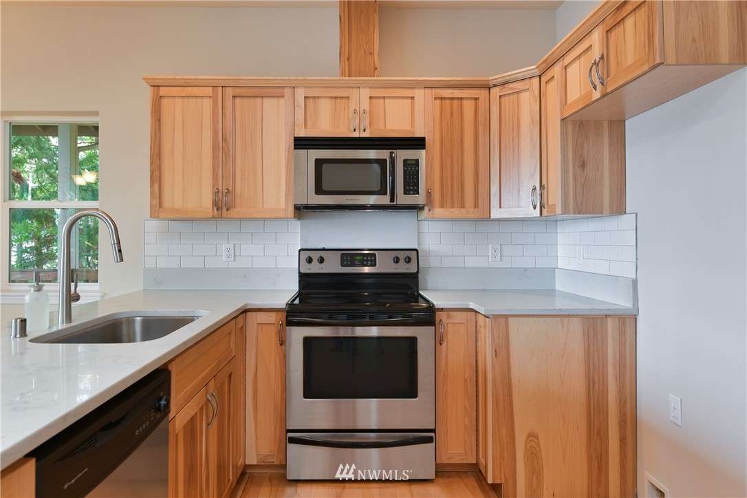 18184 Capet Zalsiluce Road La Conner, WA 98257 - Photo 12 of 25 a kitchen with stainless steel appliances granite countertop a sink stove and microwave