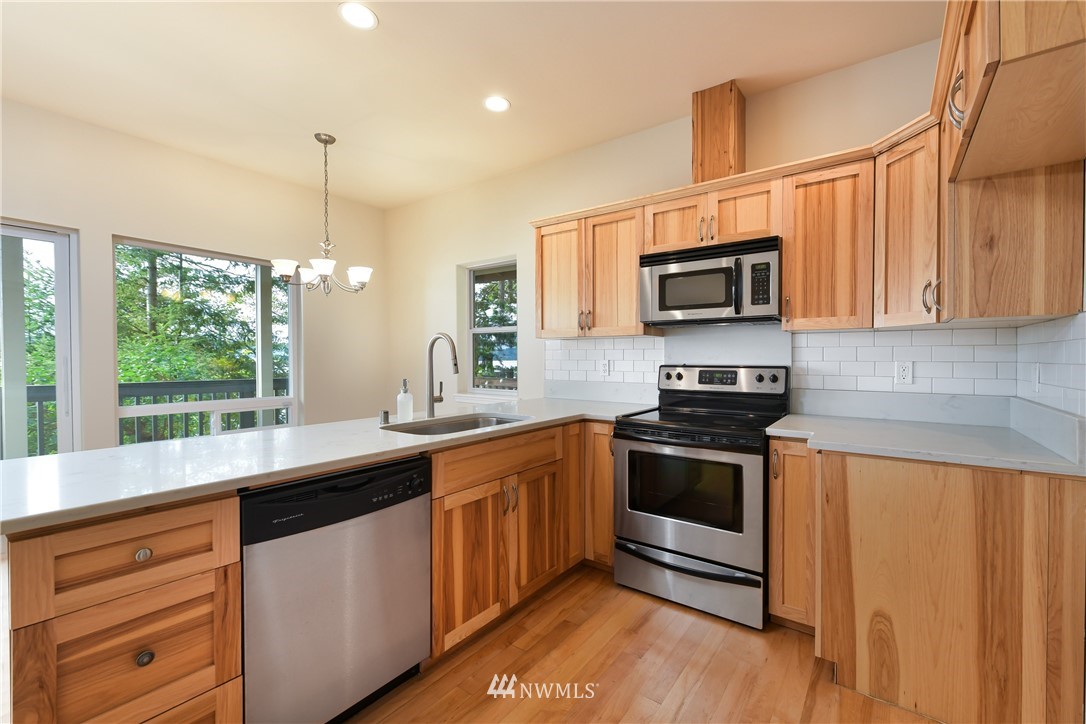 18184 Capet Zalsiluce Road La Conner, WA 98257 - Photo 13 of 25 a kitchen with stainless steel appliances granite countertop a sink a stove and a microwave