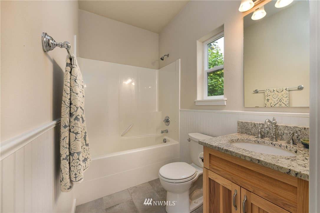 18184 Capet Zalsiluce Road La Conner, WA 98257 - Photo 16 of 25 a bathroom with a granite countertop sink a toilet and shower