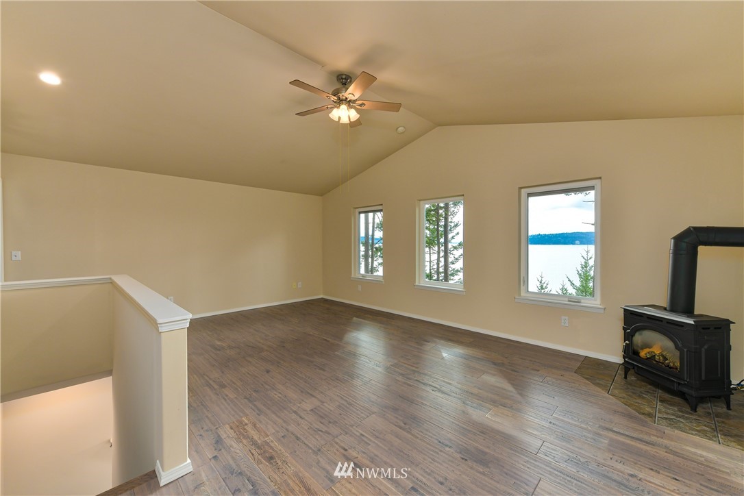 18184 Capet Zalsiluce Road La Conner, WA 98257 - Photo 17 of 25 a view of an empty room with a window and wooden floor