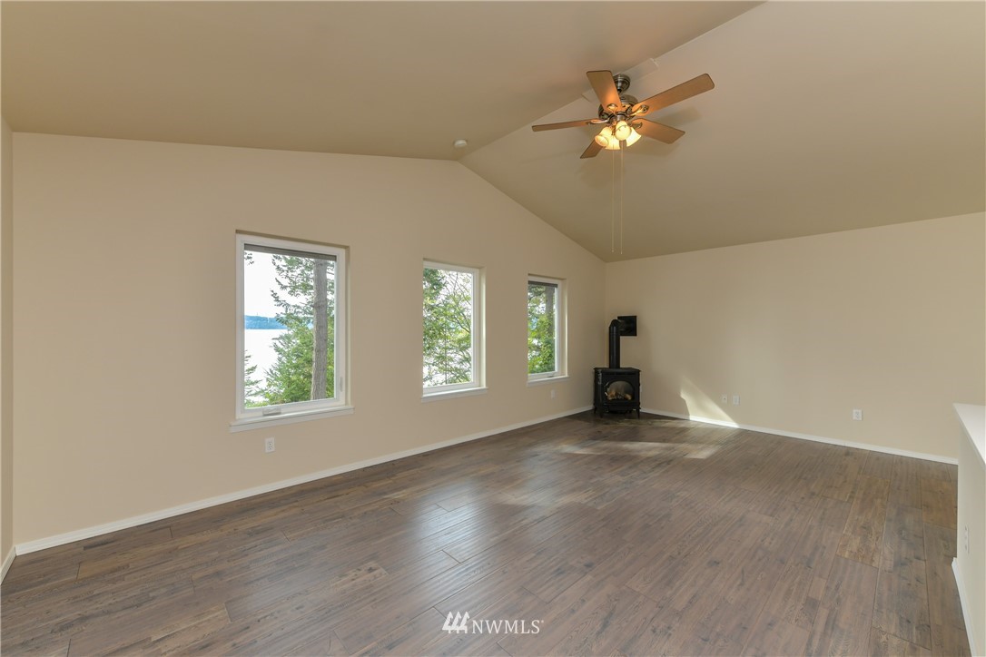 18184 Capet Zalsiluce Road La Conner, WA 98257 - Photo 18 of 25 an empty room with windows and ceiling fan