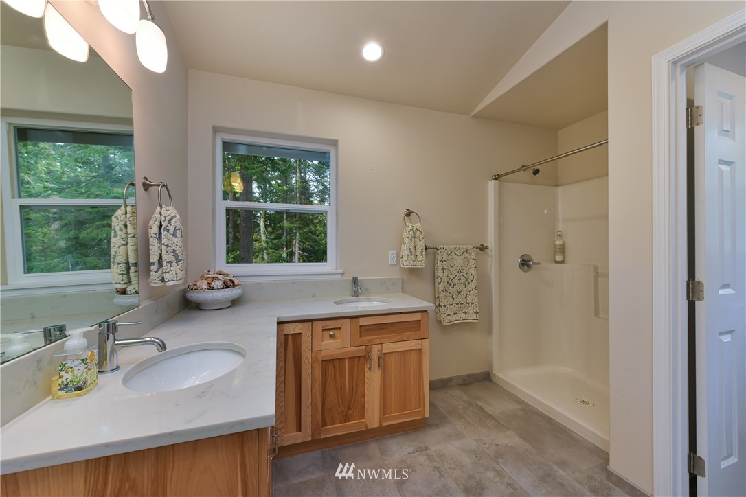 18184 Capet Zalsiluce Road La Conner, WA 98257 - Photo 20 of 25 a bathroom with a tub sink toilet window and mirror