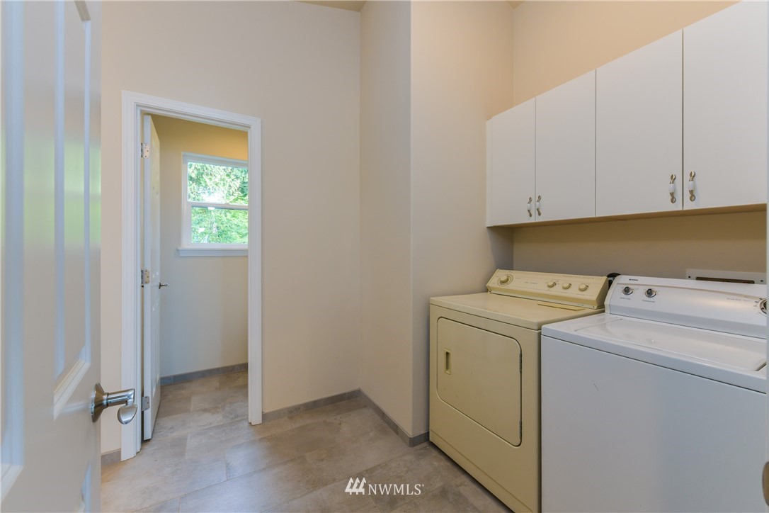 18184 Capet Zalsiluce Road La Conner, WA 98257 - Photo 22 of 25 a view of storage and utility room with washer and dryer
