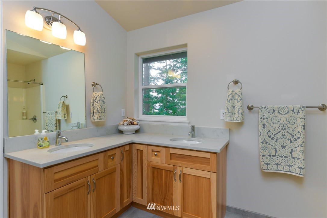 18184 Capet Zalsiluce Road La Conner, WA 98257 - Photo 23 of 25 a bathroom with a sink double vanity and a mirror