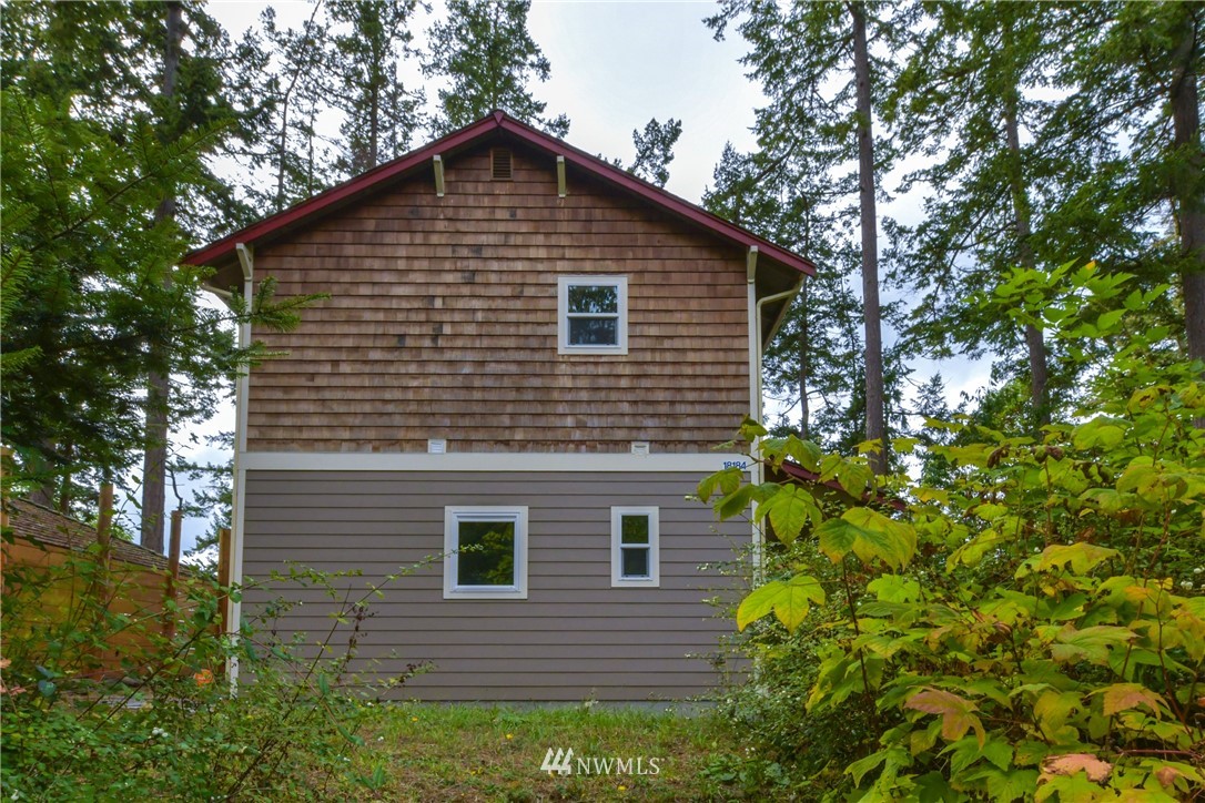18184 Capet Zalsiluce Road La Conner, WA 98257 - Photo 24 of 25 a front view of a house with plants and trees