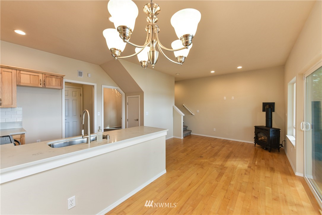 18184 Capet Zalsiluce Road La Conner, WA 98257 - Photo 10 of 25 a view of a hallway with a chandelier