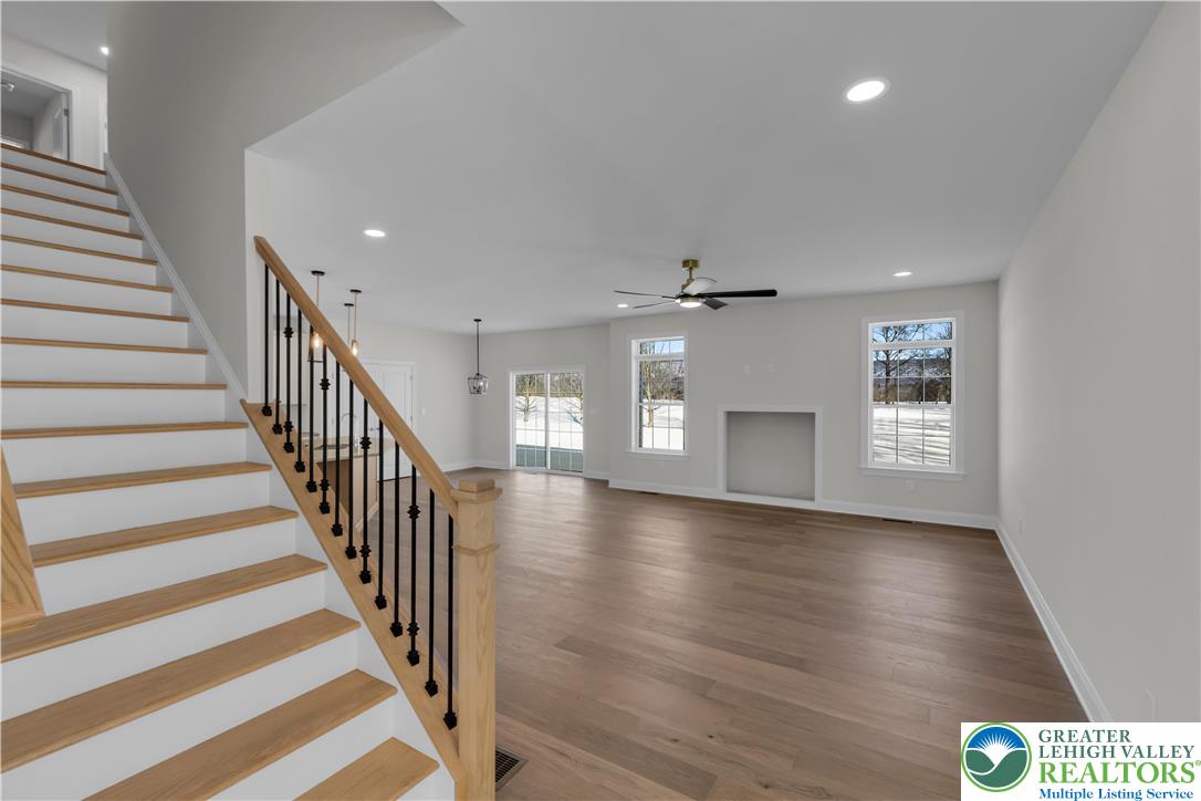 1480 Bushkill Center Road Nazareth, PA 18064 - Photo 12 of 55 an empty room with wooden floor and staircase